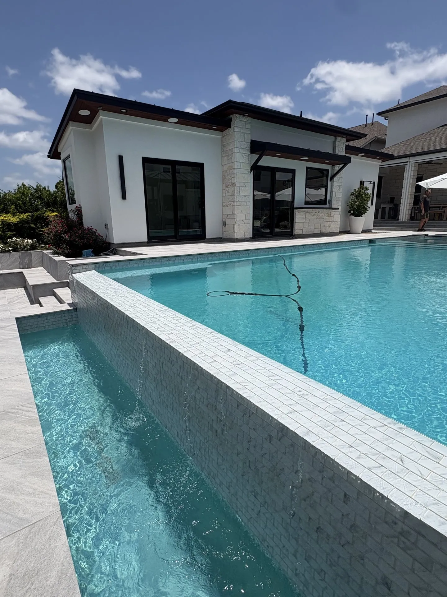Full white casita exterior beside a swimming pool
