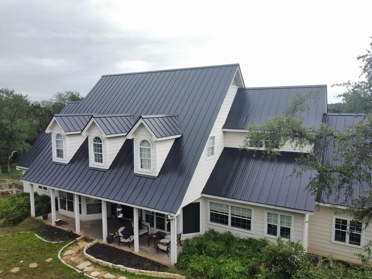 Residential home with a broad gray standing-seam metal roof