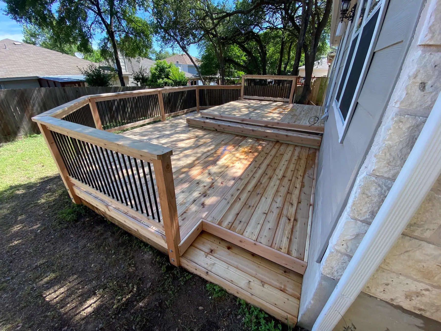 Custom freestanding deck structure in a backyard