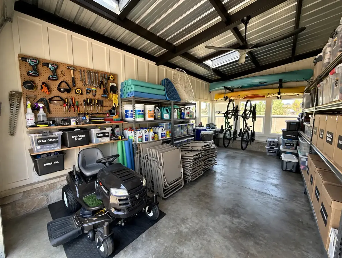 Custom storage building interior with organized tools, lawn equipment, shelves, and racks built by TWT in the Austin area
