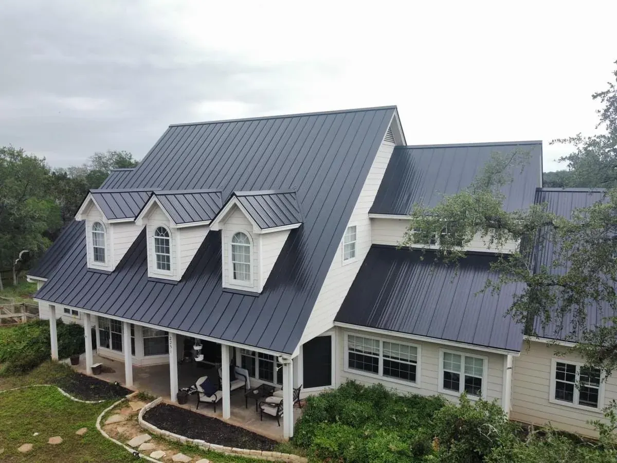 Residential home with a broad gray standing-seam metal roof